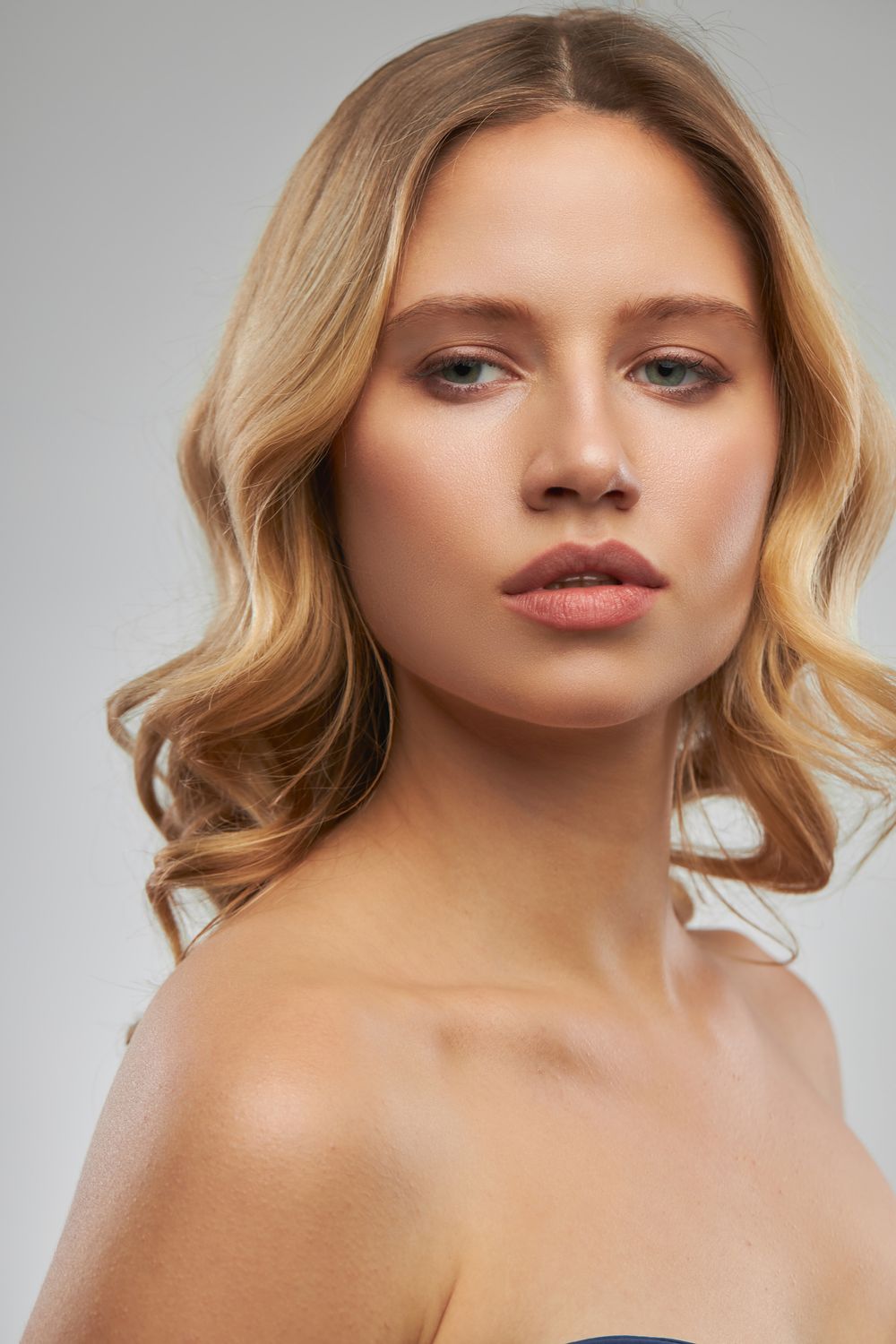 Portrait of a woman with wavy blonde hair.